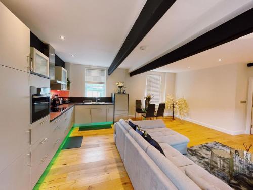 a living room with a couch and a kitchen at 73B Weavers House - Mountergate in Norwich