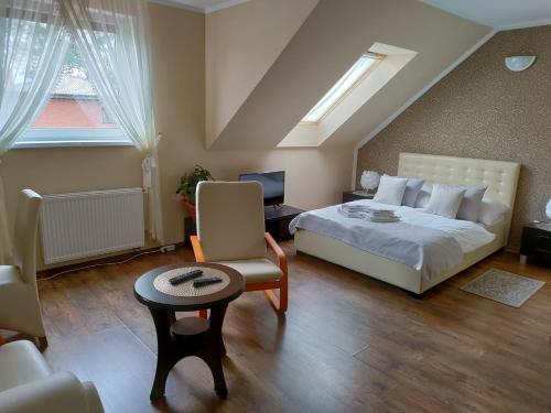 a bedroom with a bed and a desk and a chair at Zacisze Mazury in Kętrzyn
