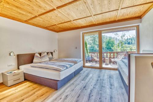 a bedroom with a bed and a large window at Residence Schnals in Senales