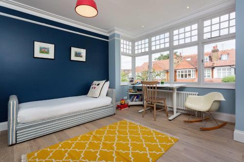 a childs room with a bed and a table and windows at Veeve - Quartz House in London