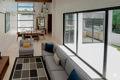 a living room with a couch and a table at Villa Casa Agua in Akumal