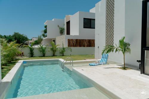 a swimming pool in front of a house at Villa Casa Agua in Akumal