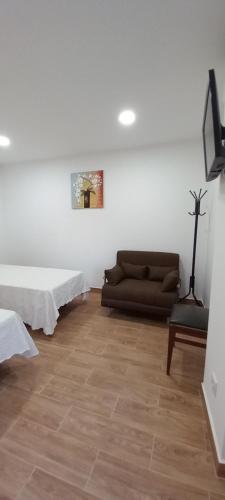 a living room with two beds and a couch at Monte da Vinha Nova in Santiago do Cacém
