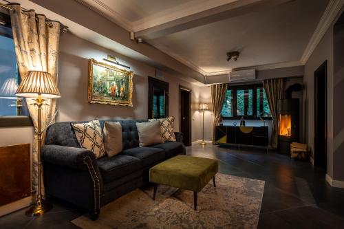 a living room with a couch and a table at Villa Trésor Voronet in Gura Humorului