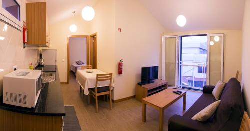 a living room with a couch and a dining room at Apartments Madeira Old Town in Funchal