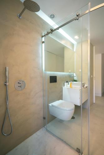 a bathroom with a shower with a toilet and a sink at PORTARIA HOUSING in Aveiro