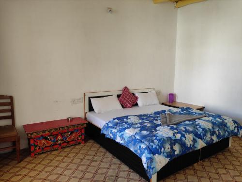a bedroom with a large bed and a table at Buddha guest House nubra in Deskit