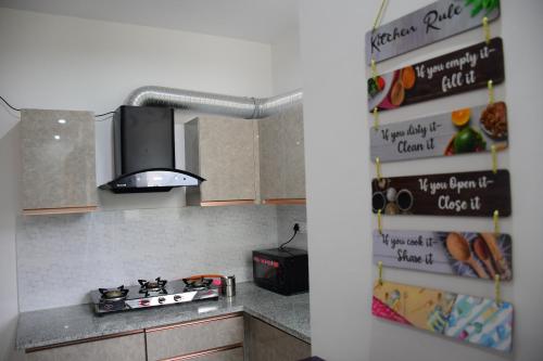 a kitchen with a sink and a stove top oven at River Stay - Homestay by Wanderlust Rural Tourism in Dehradun