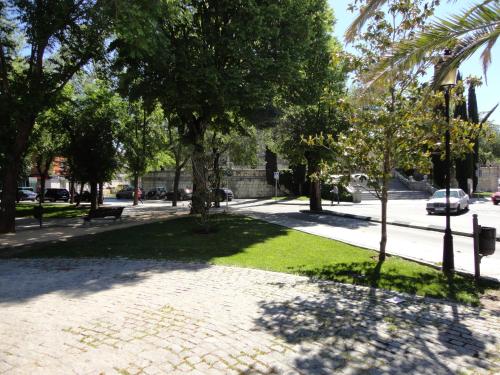 a park with trees and grass and a sidewalk at Hostal Gran Vía in Pinto