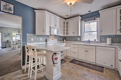 a kitchen with white cabinets and a large island at Charming Ocean City Townhome Walk to Beach! in Ocean City