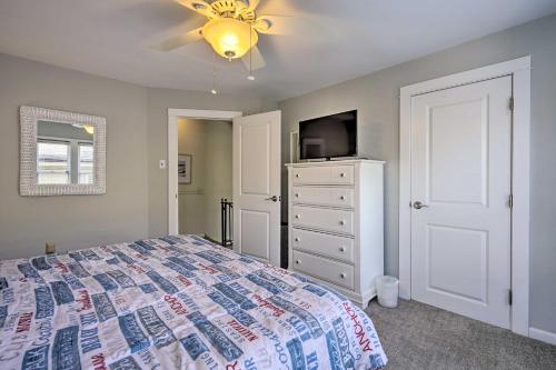 a bedroom with a bed and a dresser with a tv at Charming Ocean City Townhome Walk to Beach! in Ocean City
