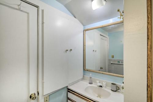 a bathroom with a sink and a mirror at Scenic Lake Almanor Home with Mountain Views! in Lake Almanor