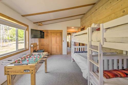 a room with bunk beds and a foosball table at Scenic Lake Almanor Home with Mountain Views! in Lake Almanor