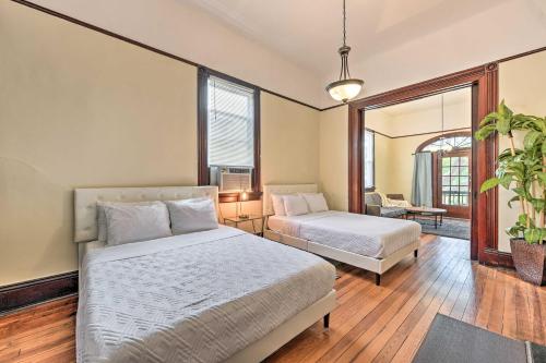 a bedroom with two beds and a couch and a mirror at Charming New Orleans Home Less Than 3 Mi to Bourbon St in New Orleans