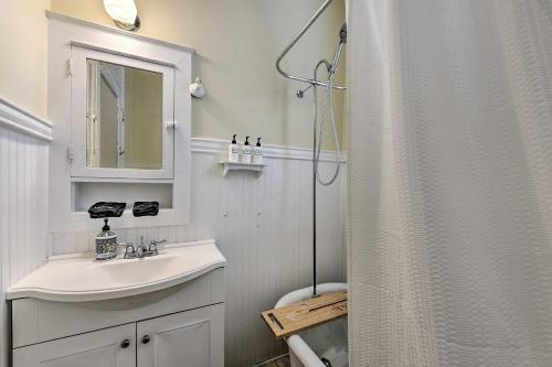 a white bathroom with a sink and a shower at Charming New Orleans Home Less Than 3 Mi to Bourbon St in New Orleans