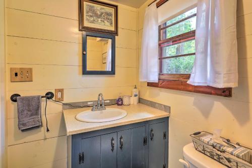a bathroom with a sink and a window at Lake Hermit Cabin with Kayaks and Paddleboards! in Sanbornton