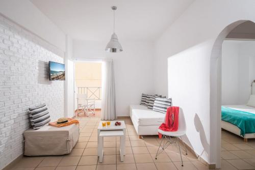 a white room with a bed and a couch at Fedra Boutique Apartments in Hersonissos
