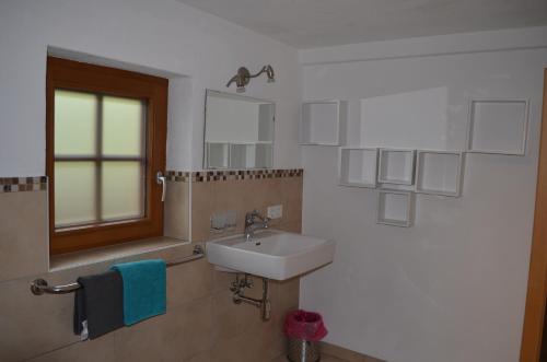 a bathroom with a sink and a mirror at Reitstall Henntalhof in Kitzbühel