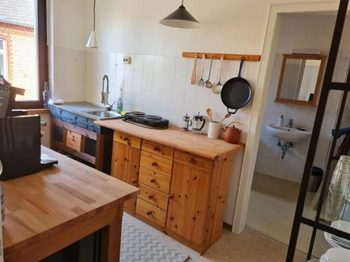 a kitchen with a wooden counter and a sink at Geschmackvolle Wohnung im Herzen von Sinzig in Sinzig