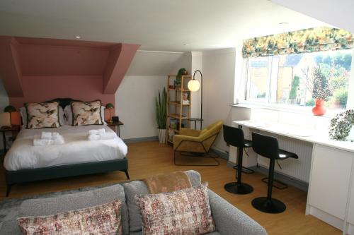 a living room with a bed and a couch at The Old Bakery in Sherborne