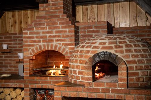 a brick oven with a fire in it at Villa Trésor Voronet in Gura Humorului