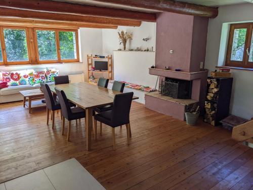 a dining room with a table and chairs and a fireplace at Rustico Tello in Linescio