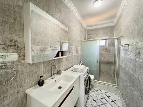 a bathroom with a sink and a shower at Avci Villa-Fethiye 3+1 in Garden with Private Pool, 10 minutes to the beach in Fethiye