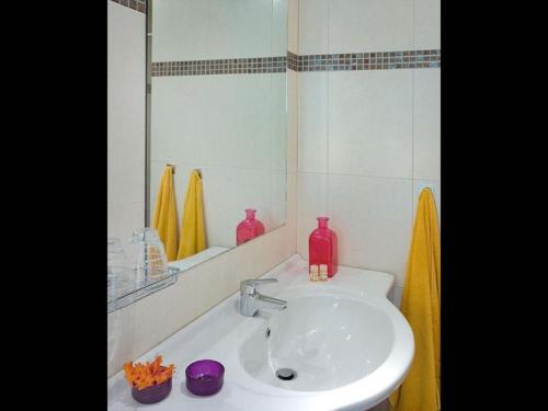 a bathroom with a sink and a mirror at One bedroom villa with private seawater pool Just 150 meters from the sea in Istron