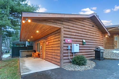 a log cabin with a door and a pay phone at The Lodges at Sunset Village in McHenry