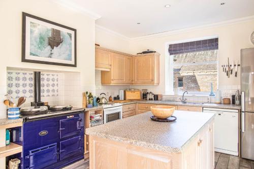 a kitchen with blue cabinets and a counter top at The Stables in Castle Douglas