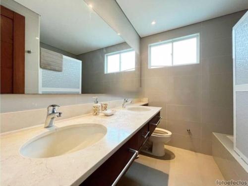 a bathroom with two sinks and a toilet at Casa Arcoíris: Espectacular casa en Cartagena con Acceso directo a la Playa in Cartagena de Indias