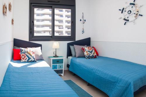 a bedroom with two beds and a window at Bahia in Arenales del Sol