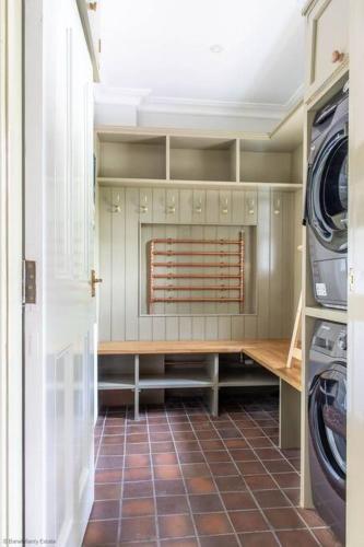 a laundry room with a washer and dryer at Culdoach in Castle Douglas