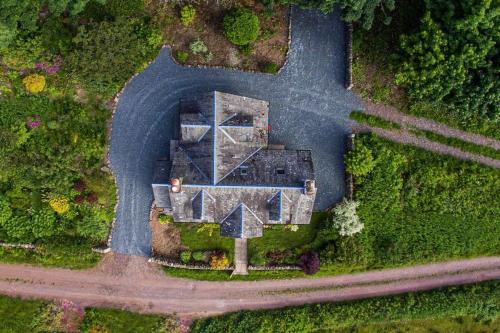 an aerial view of a house in the middle of a road at Culdoach in Castle Douglas