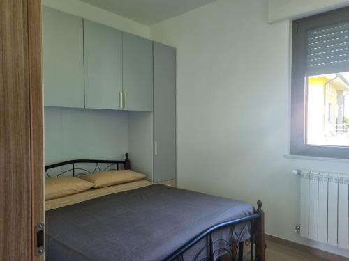 a bedroom with a bed with a cabinet and a window at La dolce vita in Scanzano
