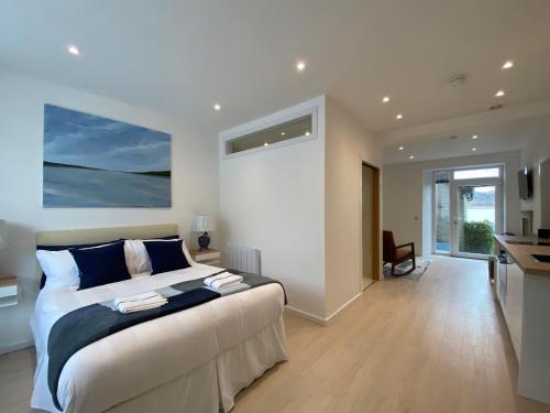 a bedroom with a large bed and a large window at Hugmish in Tighnabruaich