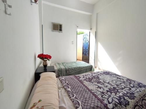 a small bedroom with a bed and a window at Flower of Desert in Luxor