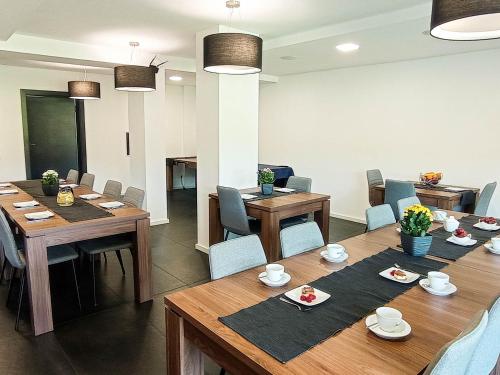 a dining room with tables and chairs and a room at Willa Monte in Wisła