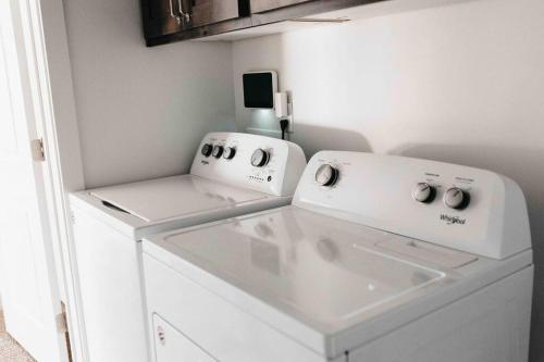 a white washer and dryer in a small room at Beautiful New 3 BR 2BA Townhome No stairs in Logan