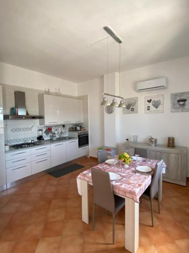 a kitchen and dining room with a table and chairs at La casa di Nettuno in Naples