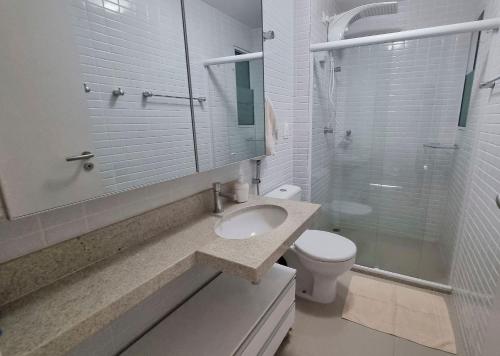 a bathroom with a sink and a toilet and a shower at Areias do Mar | 2 Quartos Garden e Completo A103 in Barra de São Miguel