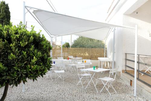 a group of tables and chairs under a white canopy at B&B Bouganville in Rilievo