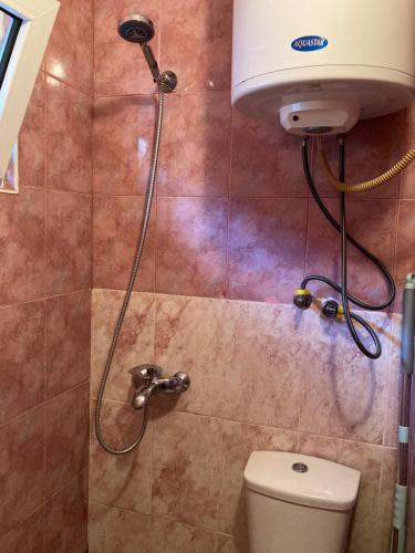a shower in a bathroom with a toilet at Apartment Kostava 10 in Batumi