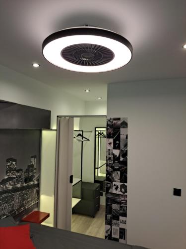 a ceiling light in a room with a mirror at Moraleja Suite I in Alcobendas