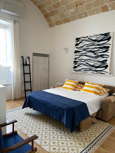 1 dormitorio con 1 cama grande con sábanas de color naranja y azul en n°21 (Casa di Anna), en Copertino