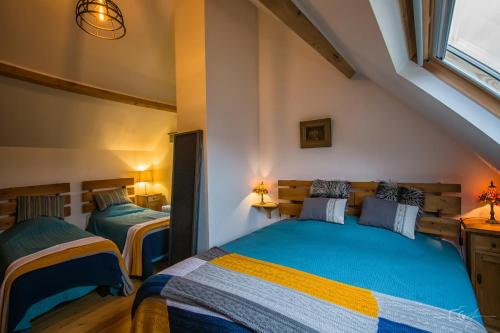 a bedroom with two beds in a attic at Maison Castor in Vresse-sur-Semois