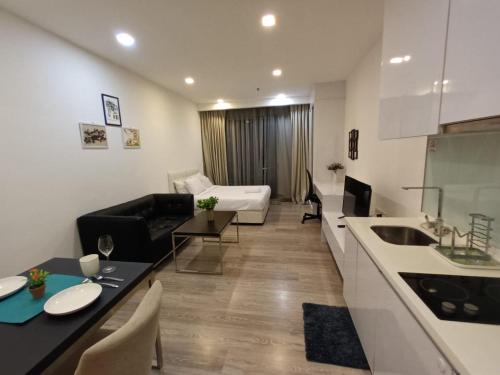 a kitchen and a living room with a bed and a couch at City Home Suites Kuala Lumpur City Centre in Kuala Lumpur