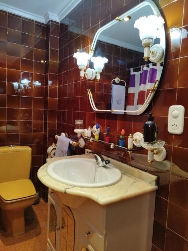 a bathroom with a sink and a mirror at Elche Holidays in Elche