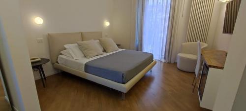 a small bedroom with a bed and a table at Stella CasaBono in Sulmona