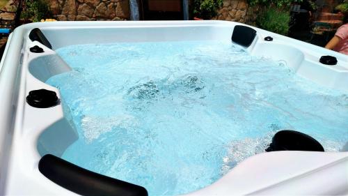 a bath tub with blue water in it at Casa Prana in Ávila